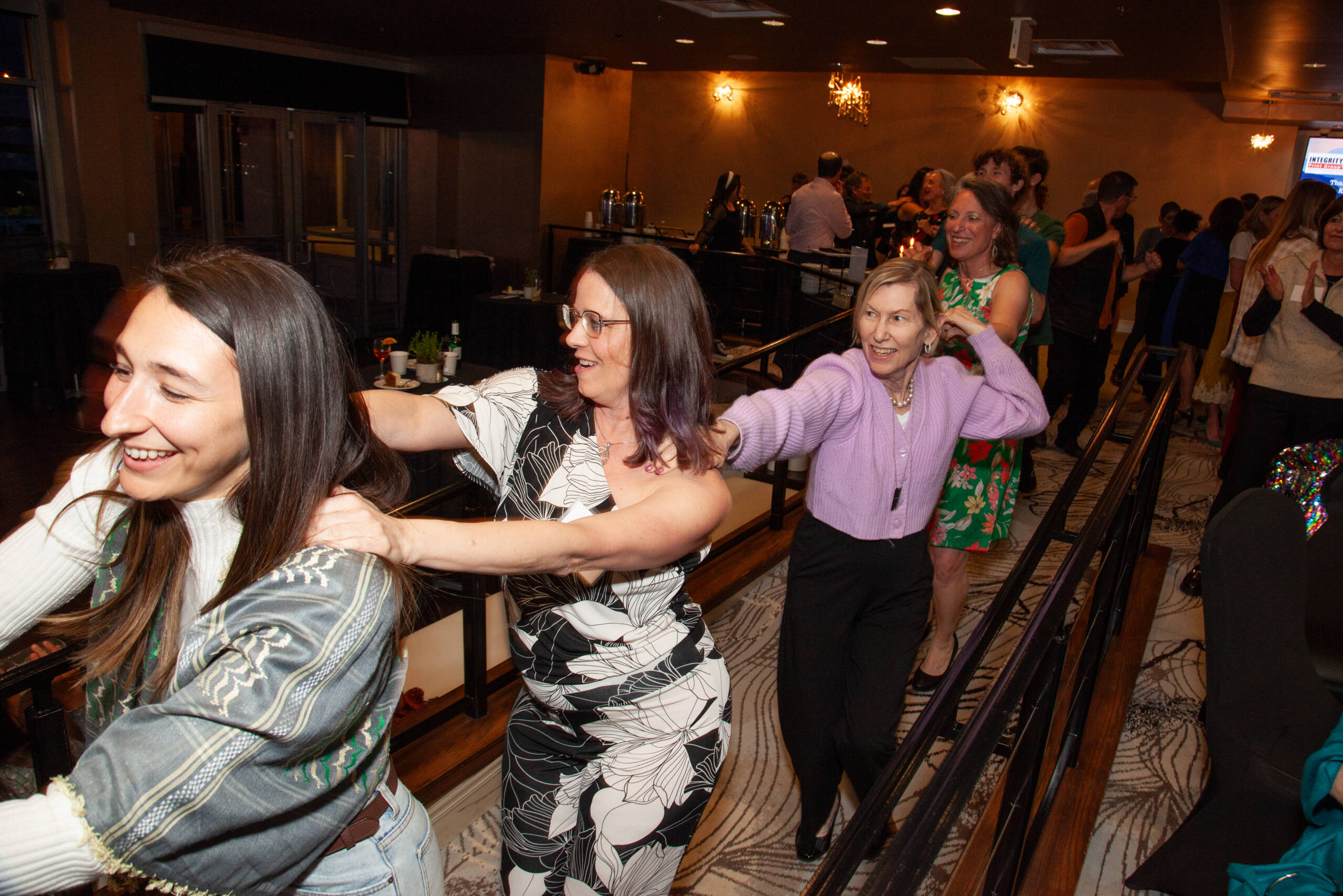 Photo of women dancing in a conga line