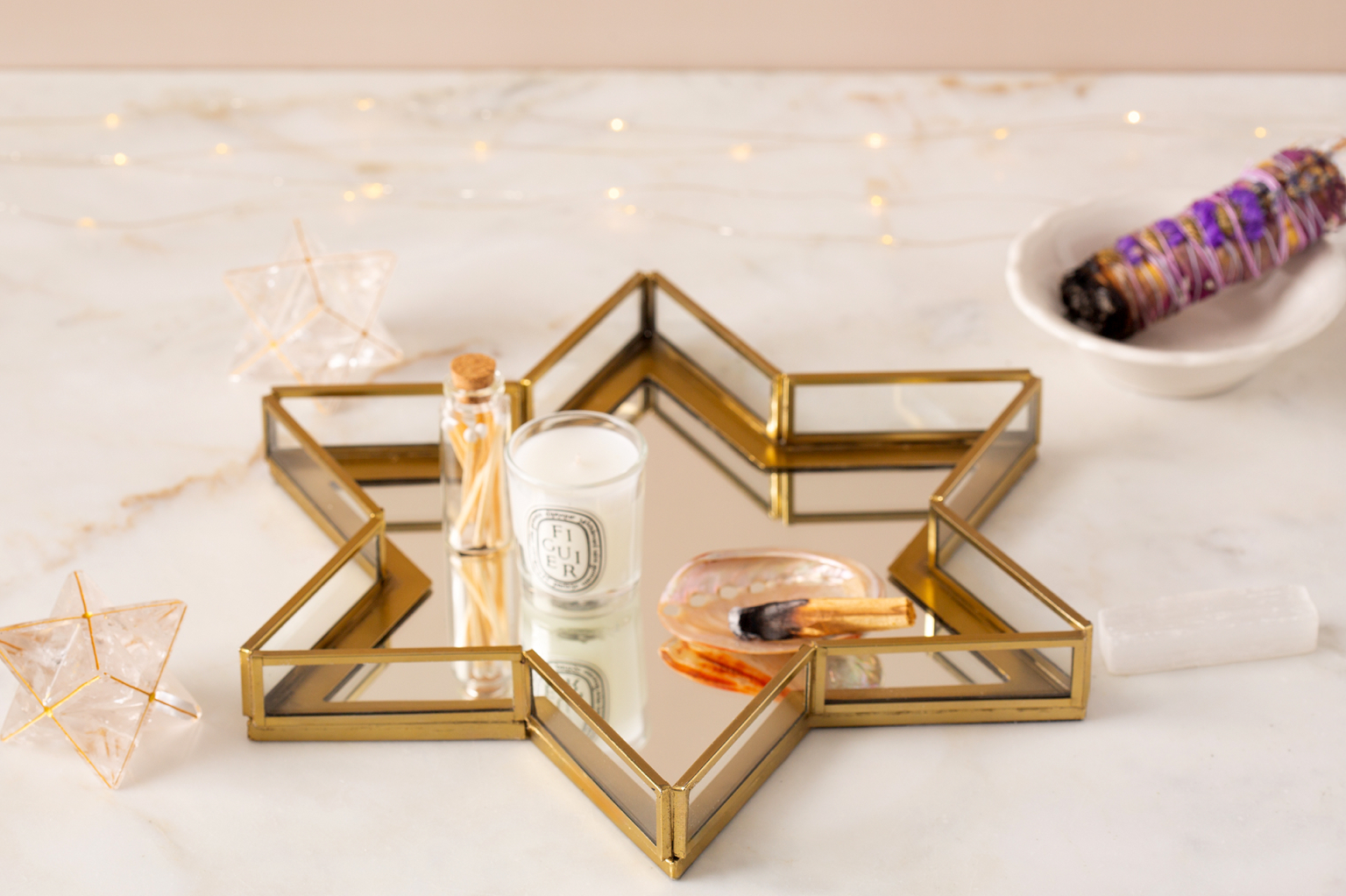 A candle on a tray in the shape of the star of David